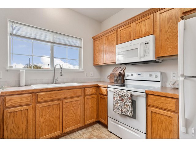 Property Photo 8 Functional kitchen that is clean, bright, and ready for your favorite meals.