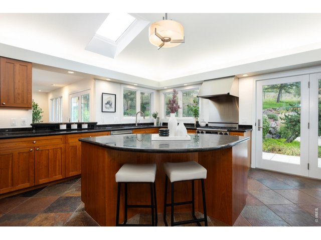 Property Photo 13 The gourmet kitchen impresses with wood cabinetry, a center island/breakfast bar, granite countertops and stainless steel appliances. 