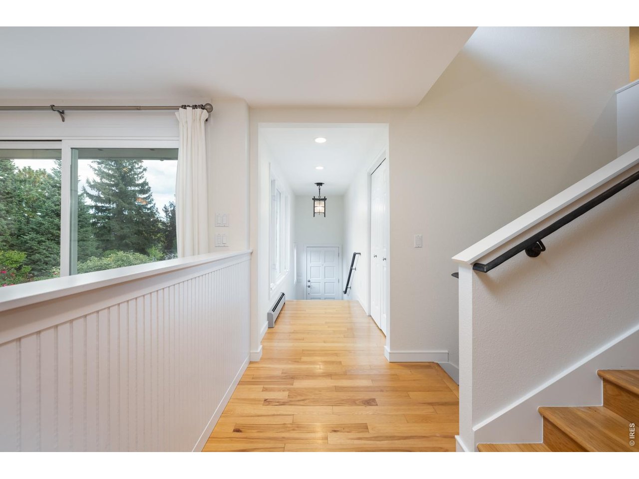Entry way with stunning hardwood flooring and spacious coat closet.
