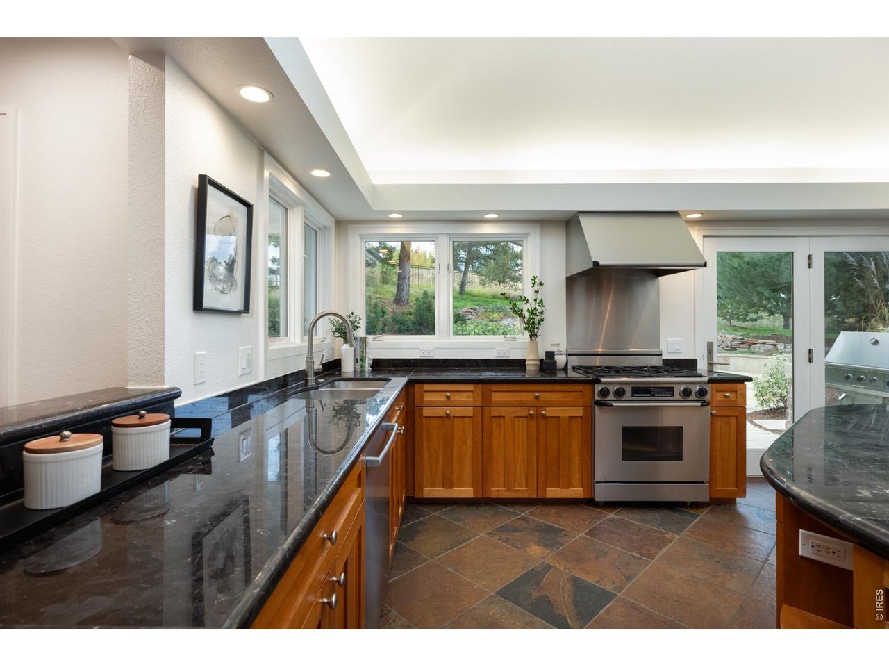 Large windows and skylights usher in amazing light and views while glass doors make al fresco entertaining irresistible!