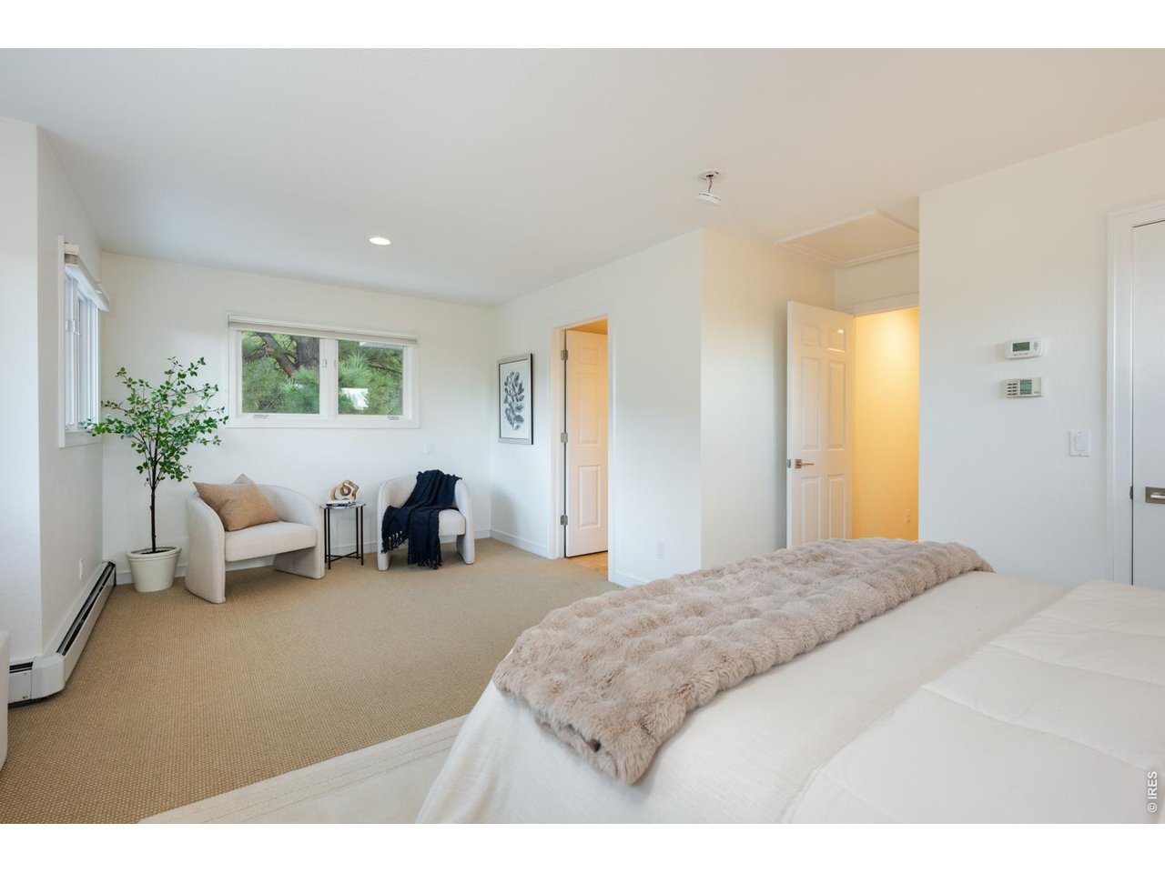 This oversized primary suite boasts a reading nook and walk-in closets in the bedroom and hall. 