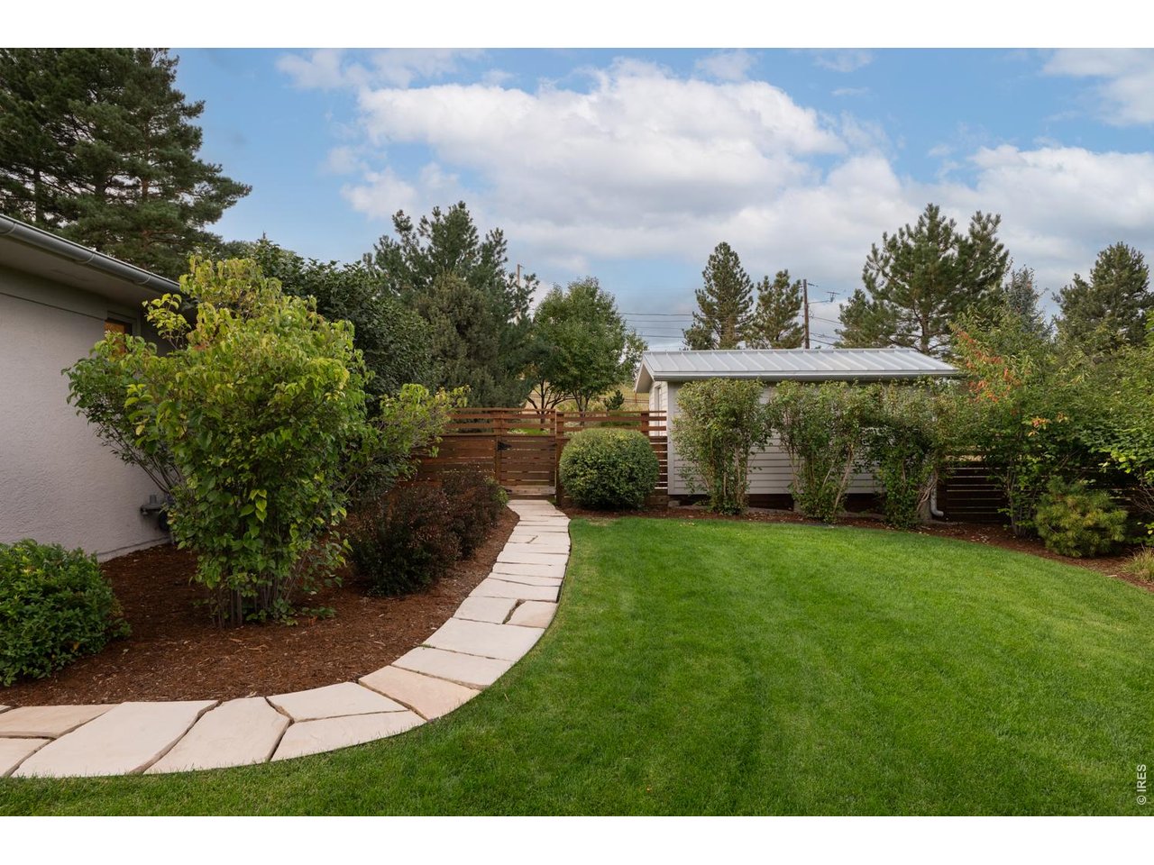 Flagstone footpath leads to private backyard oasis.