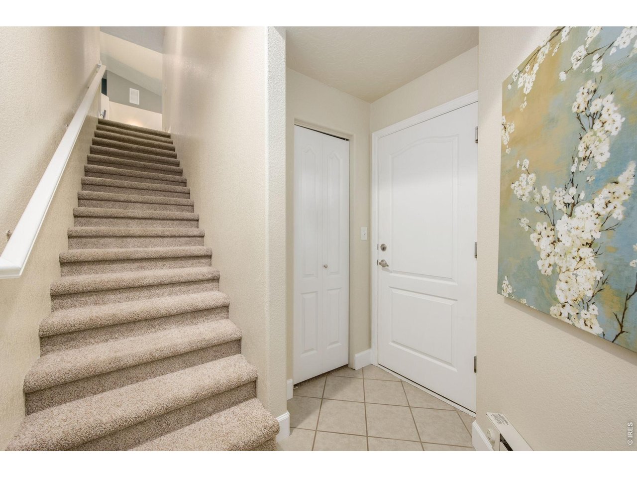 Entry with garage access, coat closet and stairs to upper unit.