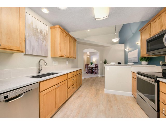 Property Photo 3 Kitchen featuring solid quartz countertops.