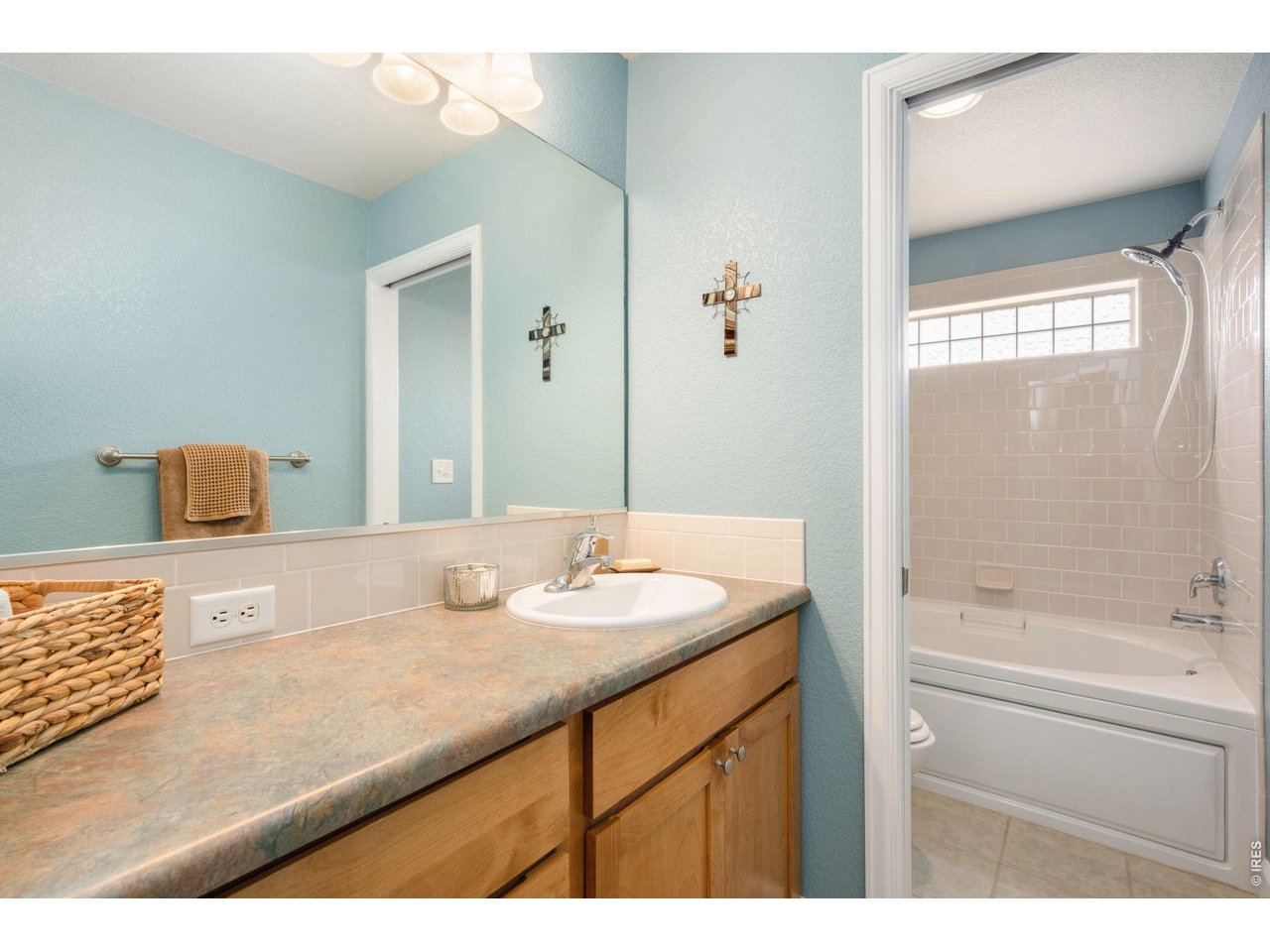 Generous second bathroom with large vanity and deep soaking tub. 