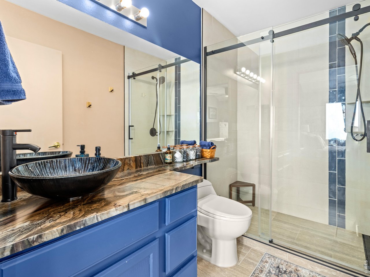 Primary suite has brand new walk-in shower, updated sink, countertop, tile, and toilet.