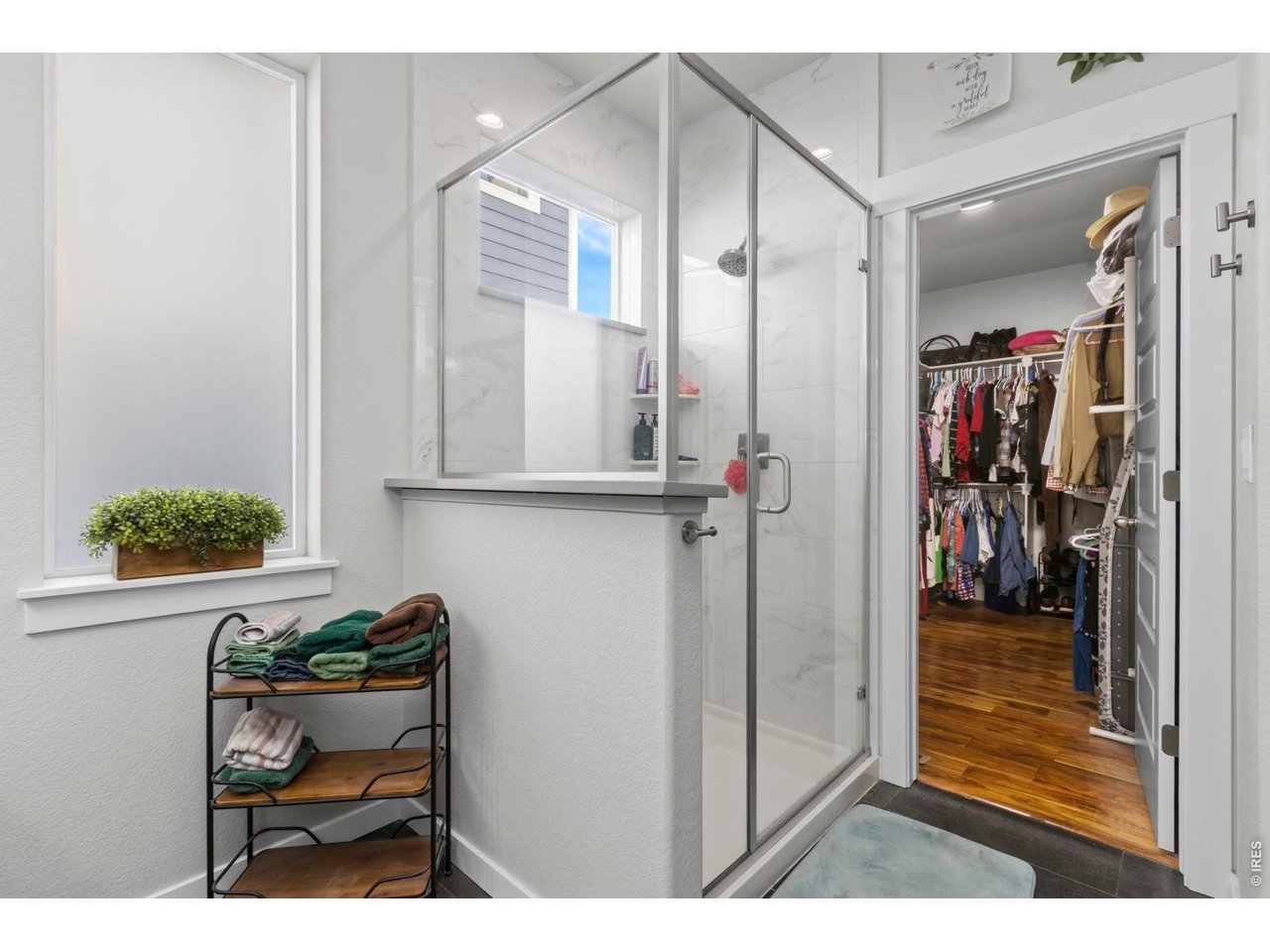 Shower includes floor to ceiling tile. Conveniently the spacious walk in closet is just around the corner