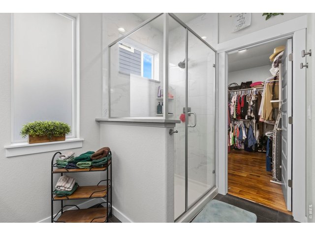 Property Photo 23 Shower includes floor to ceiling tile. Conveniently the spacious walk in closet is just around the corner