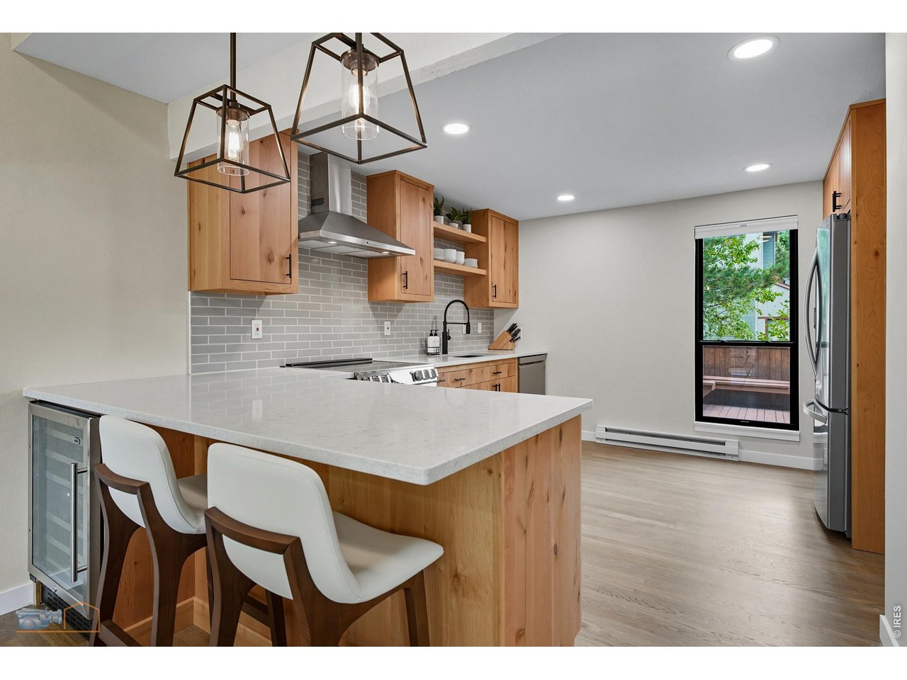 Renovated kitchen with custom Knotty Alder cabinets, new high-end appliances, Quartz counters, and white oak hardwood floors. 