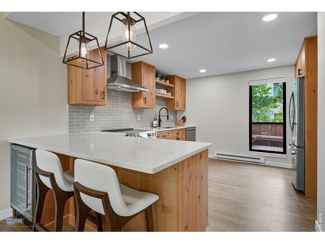 Property Photo 4 Renovated kitchen with custom Knotty Alder cabinets, new high-end appliances, Quartz counters, and white oak hardwood floors. 