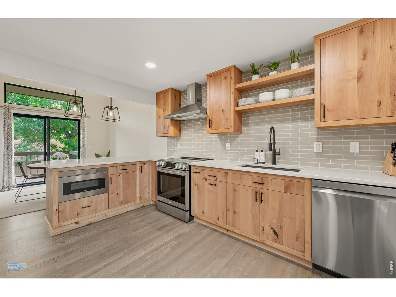 Great flow from kitchen + peninsula into dining area and then out to the expansive deck. 