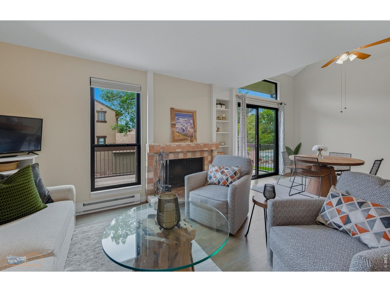 Inviting living room with a wood burning fireplace and new windows & sliding door out to the back deck. 