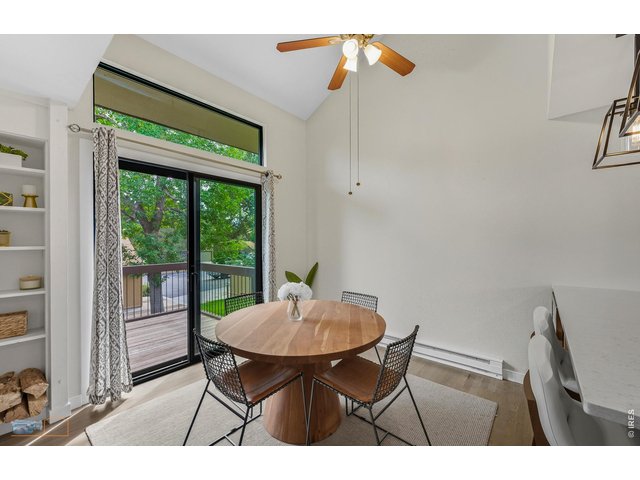 Property Photo 8 Vaulted ceiling in the dining area and pretty transom window above the sliding glass door out to the deck. 