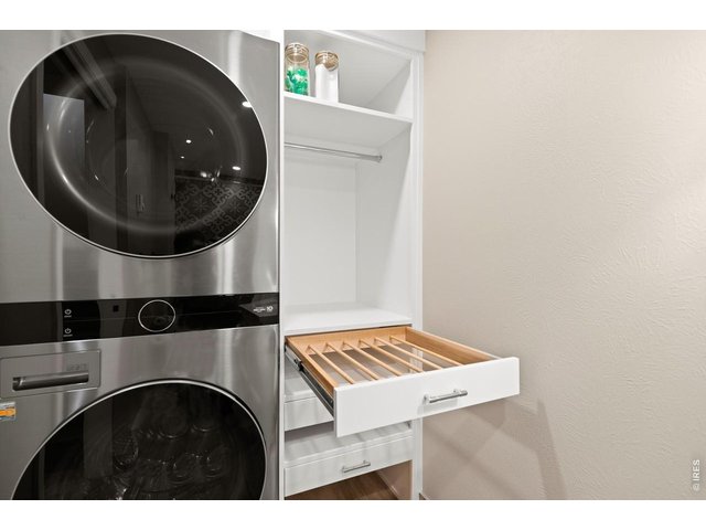 Property Photo 23 Custom laundry built in complete with new washer & dryer and pull out drying racks