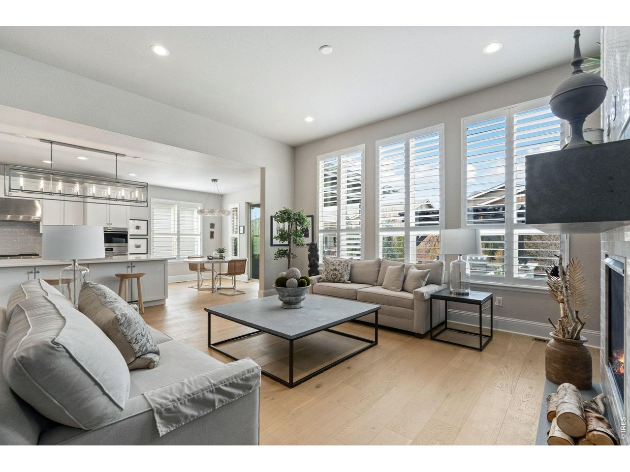 Plantation shutters and custom millwork provide refined character, while the open-concept design allows effortless flow from room to room