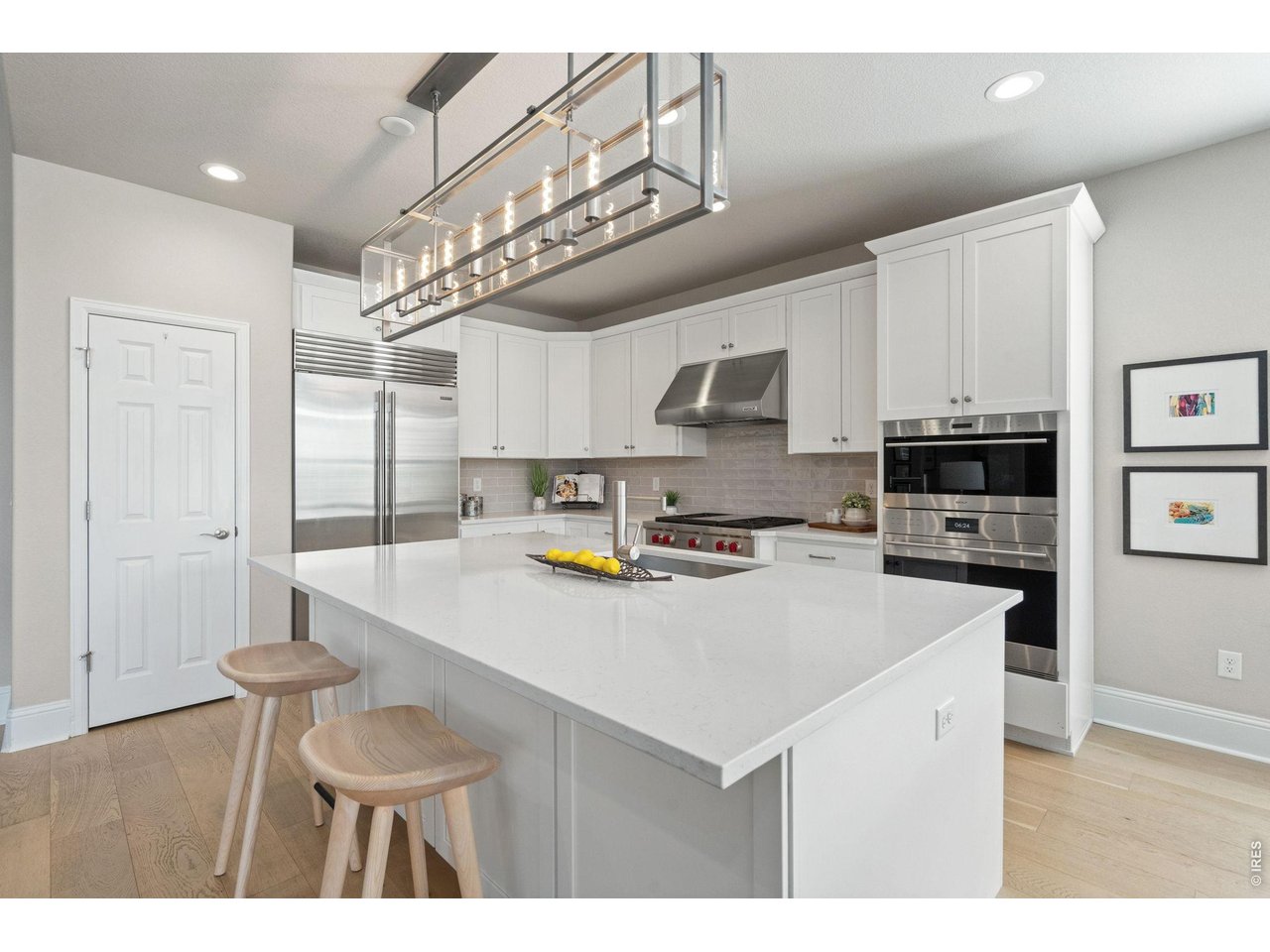 A gathering place. A statement of how beautifully life can be lived. A grand quartz island invites gathering and conversation beneath upgraded designer lighting