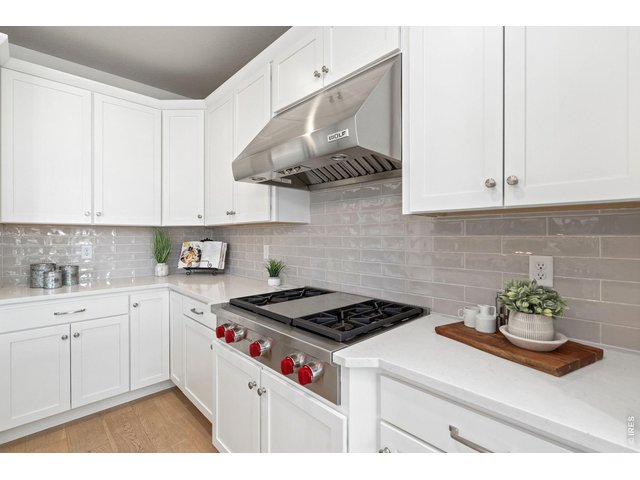 Property Photo 13 At the center of the home, the kitchen is a statement of sophistication and intention! All Wolf Appliances, including a gas stove top, subzero refridgerator/freezer, dishwasher, built-in microwave and oven, BBQ.
