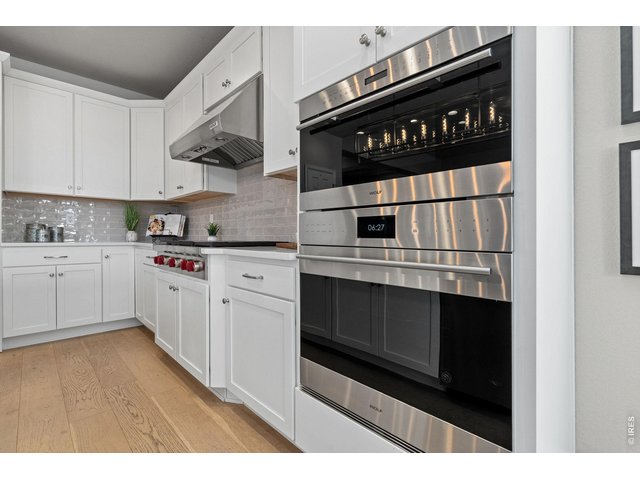 Property Photo 17 A professional suite of Wolf stainless steel appliances elevates every culinary experience.