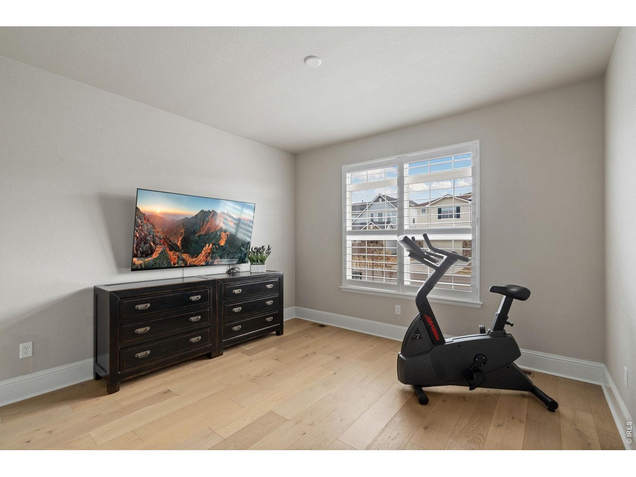 A secondary main floor bedroom offers flexibility for guests or creative pursuits