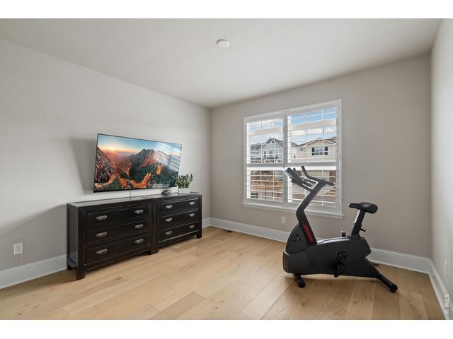 Property Photo 32 A secondary main floor bedroom offers flexibility for guests or creative pursuits