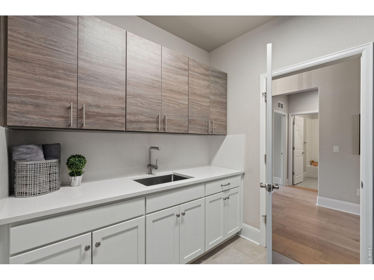 Custom cabinetry and a sink make the main floor laundry both beautiful and functional. 