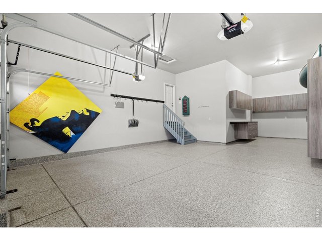 Property Photo 36 3-Car Tandem Garage with Epoxy Flooring & Custom Storage