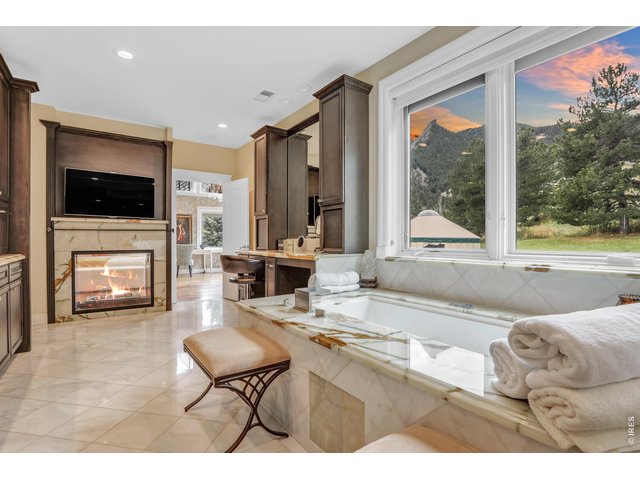 Property Photo 19 Spa-like primary bath with his and hers vanities, an oversized soaking tub and walk-in closet.