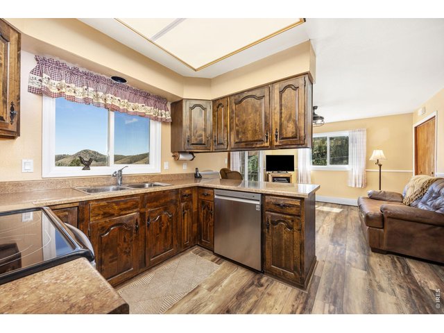 Property Photo 14 The kitchen features generous cabinet and counter space, stainless steel electric range and microwave, and all appliances are in excellent condition.