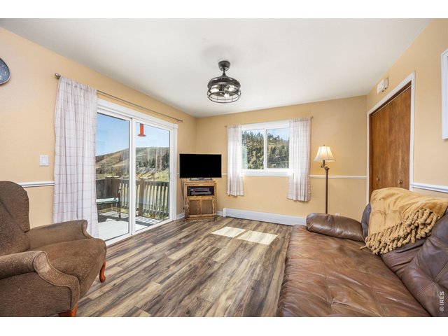 Property Photo 16 The cozy family room offers comfort and mountain views. A great place to relax & watch TV while taking in the surrounding landscape.