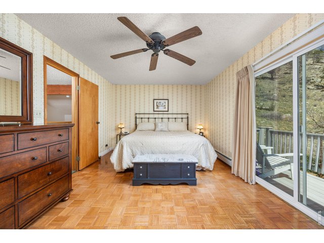 Property Photo 21 Upstairs, the spacious primary suite includes a full bath and a private south-facing deck with the best views on the property.