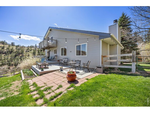 Property Photo 30 Outside, enjoy a 720 sq ft barn, three sheds (including one suitable as a chicken coop), mature irrigated landscaping, garden beds, and a water feature
