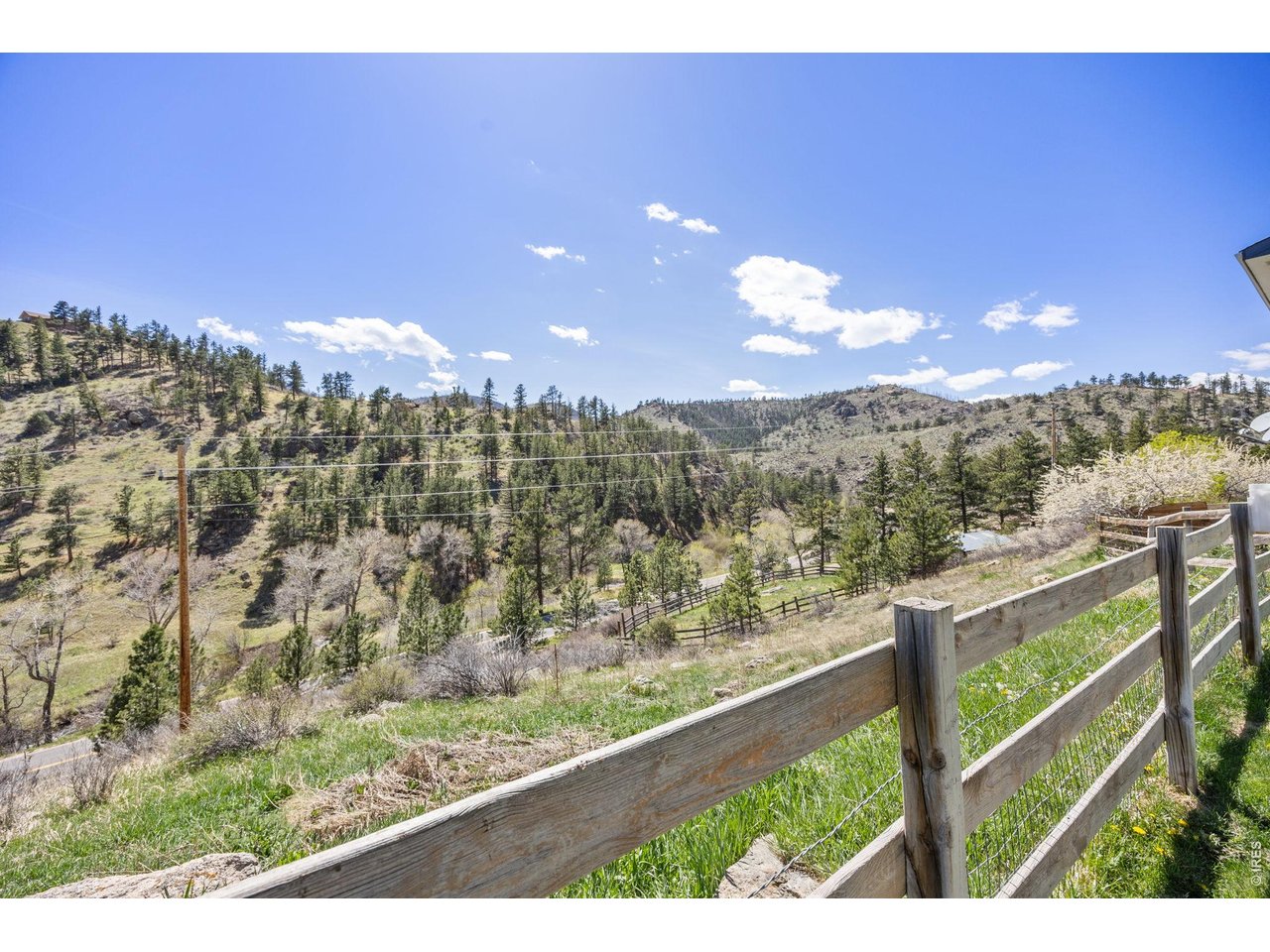 Outside, enjoy a 720 sq ft barn, three sheds (including one suitable as a chicken coop), mature irrigated landscaping, garden beds, and a water feature