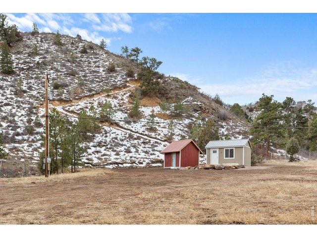 Property Photo 9 Tiny house, storage shed (left) and hiking track to upper portion of land and National Forest 