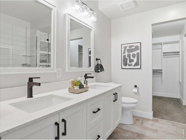 Property Photo 15 Spacious Walk in Closet with built in shelving. Washer/Dryer located in area off closet.