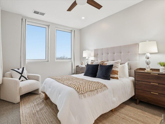Property Photo 3 Serene primary bedroom offering comfort and privacy.