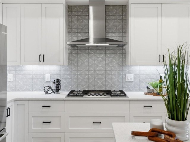 Property Photo 7 Contemporary kitchen featuring premium appliances and clean lines.