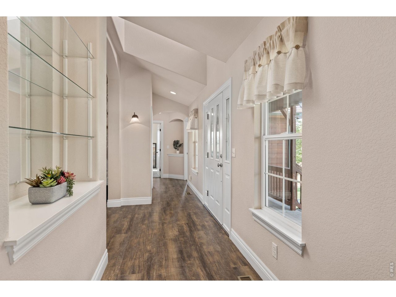 From the entry space a hallway leads you along the front of the interior.