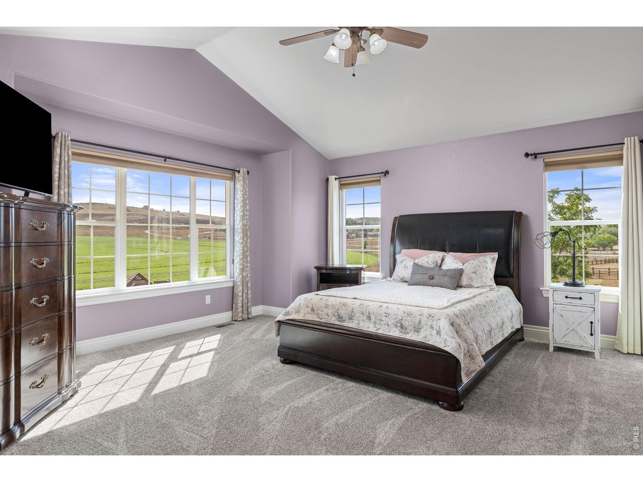 The Primary Bedroom with Vaulted Ceilings and views out every window!