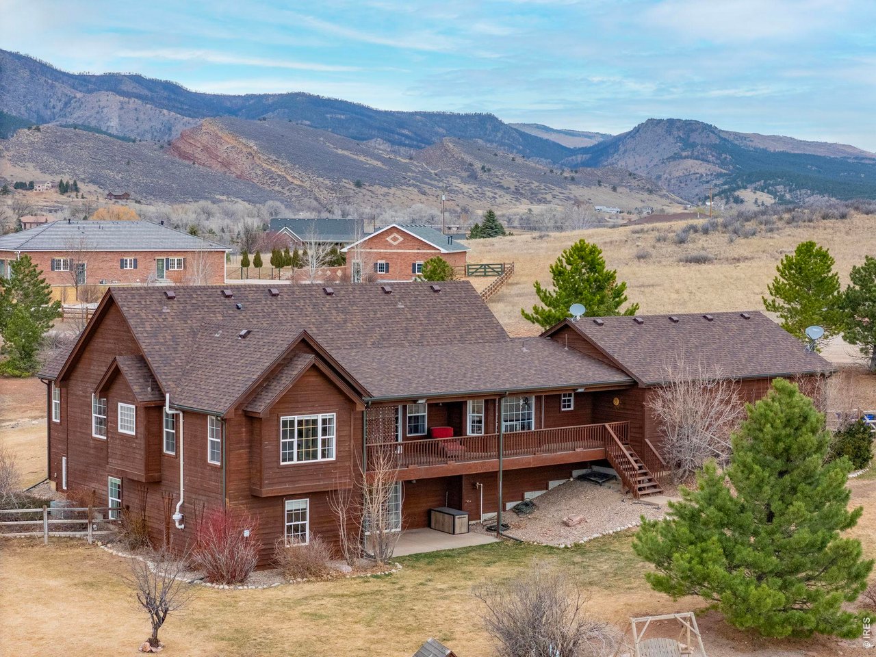 View of the back of the home with Covered Deck and Lower Patio. Also showcasing that brand new Class IV Roof!
