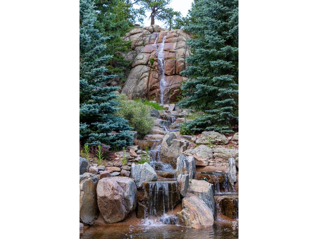 Property Photo 4 Look at this massive waterfall, (after which the estate is named) visible from the back patio. This water cascades 30 feet, reinforcing the serenity that can only be found in the wild.