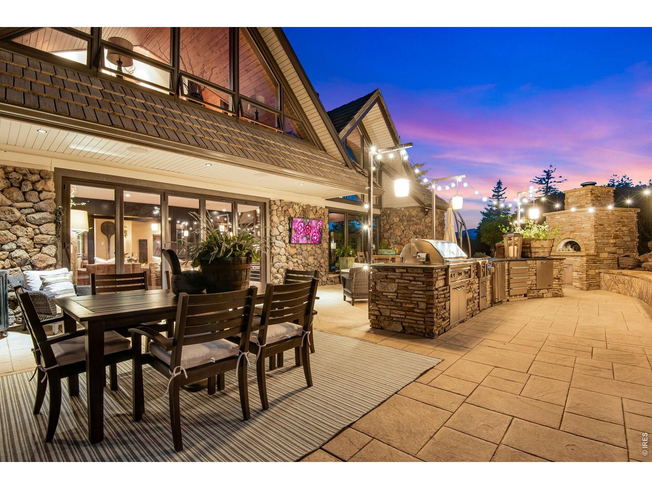 Step outside onto the patio to barbeque, cook a pizza in the pizza oven, laugh, lounge, and watch TV next to the pond and numerous water features