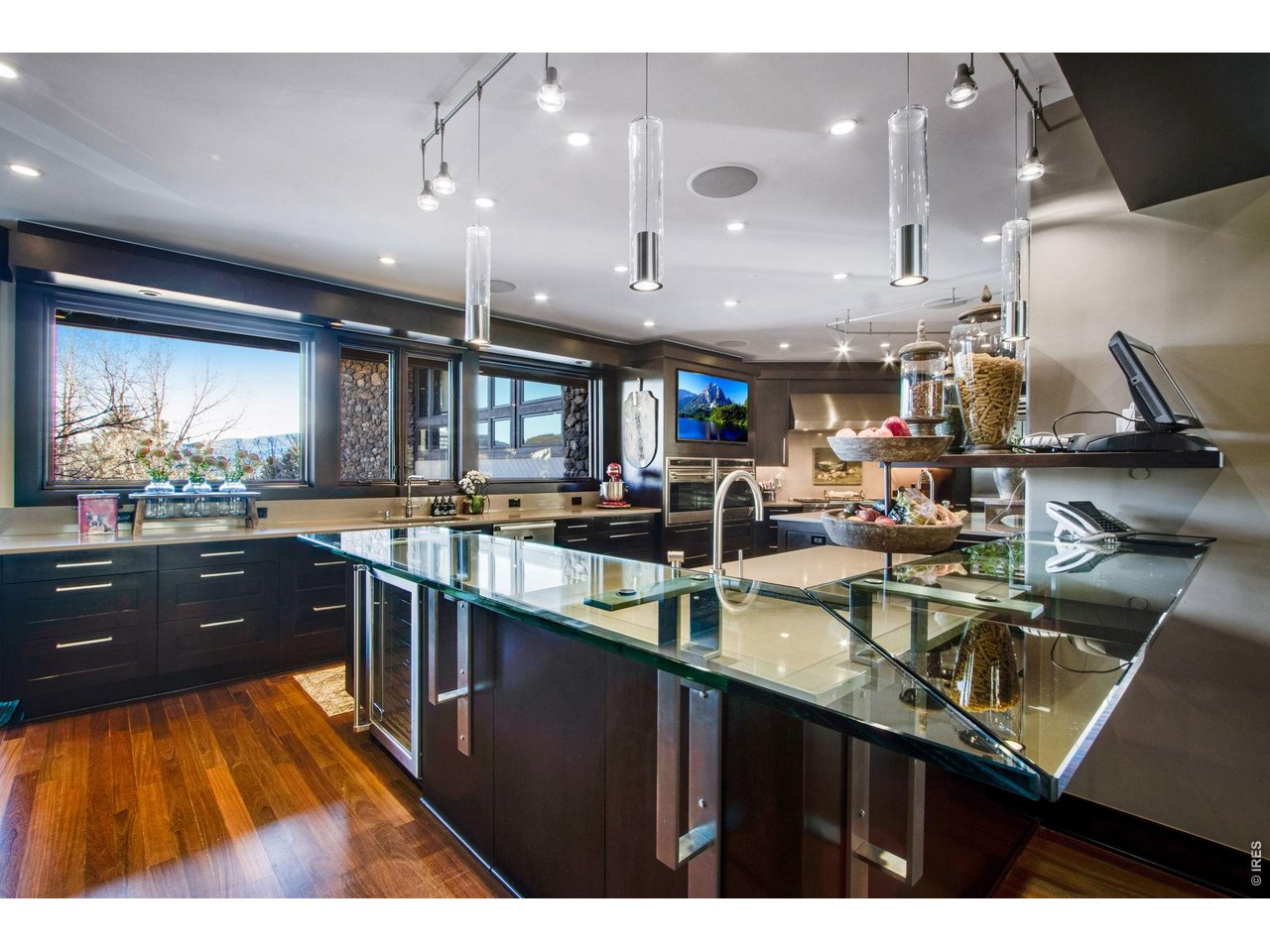 The gourmet kitchen is a culinary delight, equipped with custom Irpina cabinets, Sub-Zero Pro Package, 2 Wolf ovens and gas cook-top, 2 warming drawers and 2 Miele Dishwashers.
