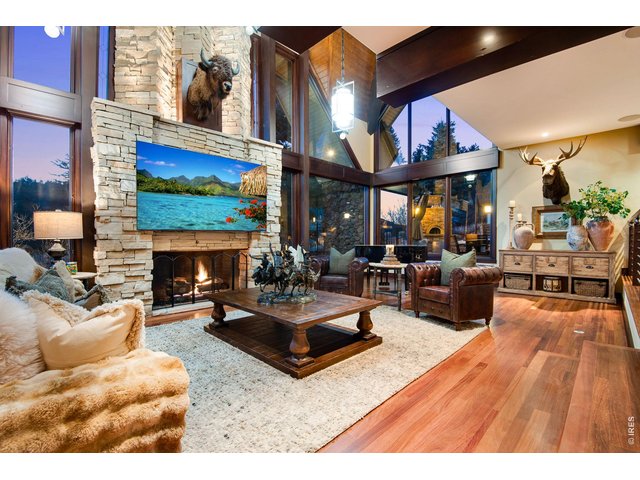 Property Photo 13 The main residence is a testament to impeccable craftsmanship and architectural design, with vaulted ceilings, wooden beams, picture windows capturing mountain vistas, and tranquil water features.