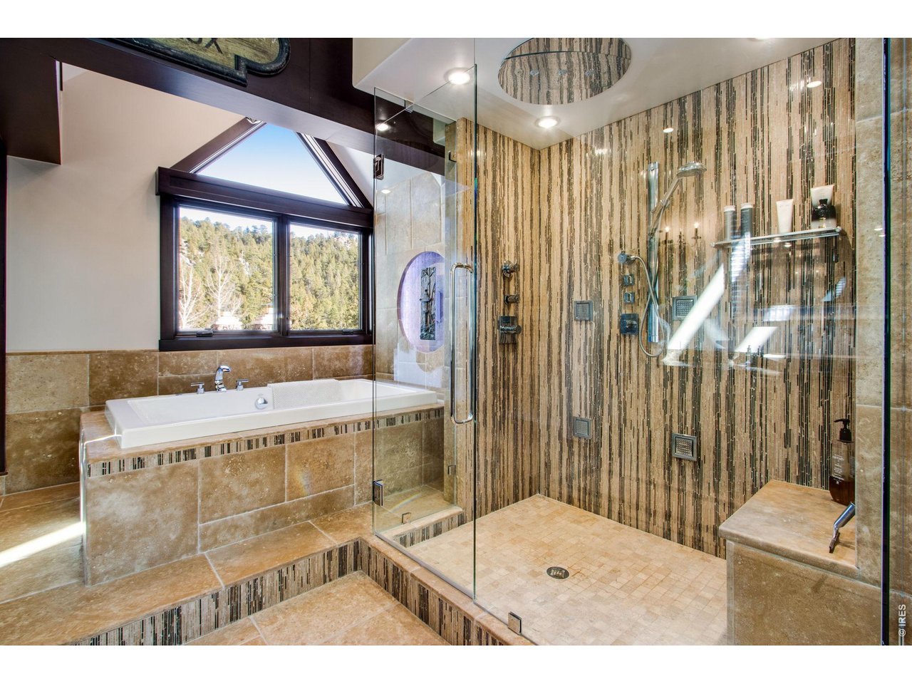 Huge ensuite primary bathroom with deluxe shower and bathtub for soaking.