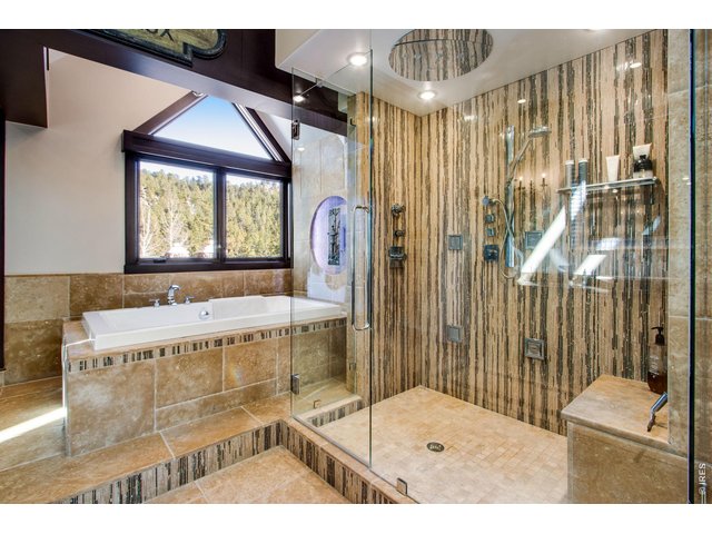 Property Photo 27 Huge ensuite primary bathroom with deluxe shower and bathtub for soaking.