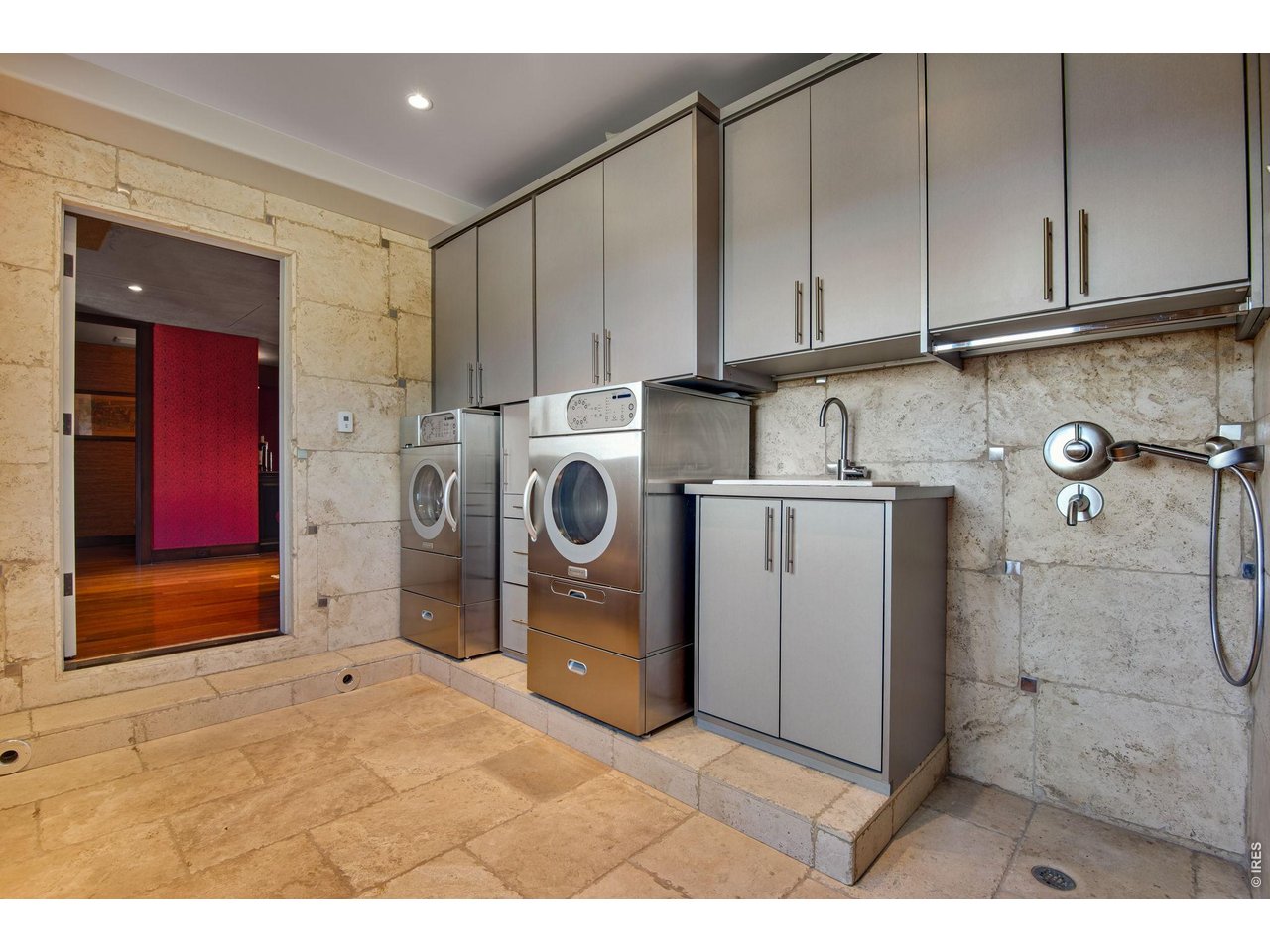 Another laundry area with a doggy wash center is connected to the 4-car tandem garage. This room also functions as a great shake off room when coming from the garage.