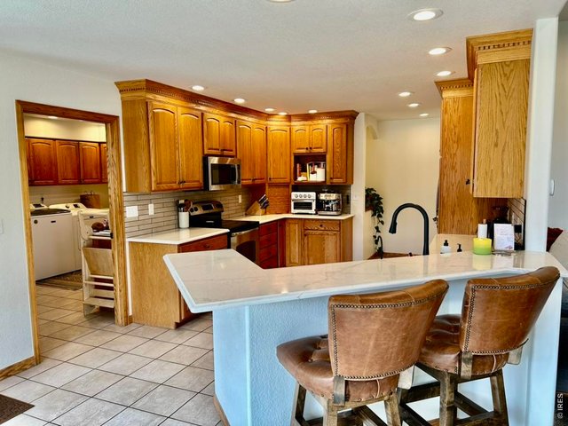 Property Photo 18 Kitchen & Entry to Laundry Room