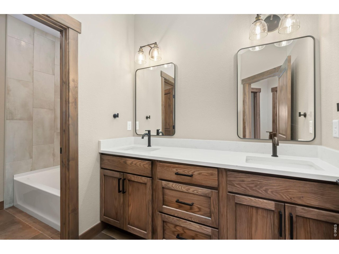 Property Photo 14 Upstairs bathroom with double sinks and quartz.