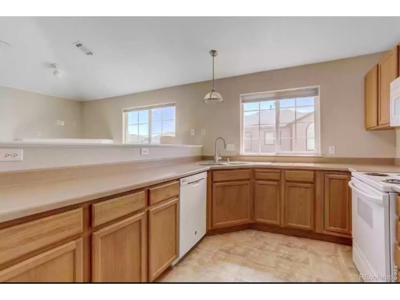 Big kitchen with plenty of counter and cabinet space, corner stainless sink with amazing light from southern exposure.