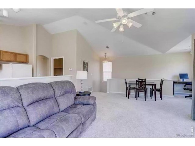 Property Photo 6 Good sized living room with gas fireplace and sliding door to balcony.